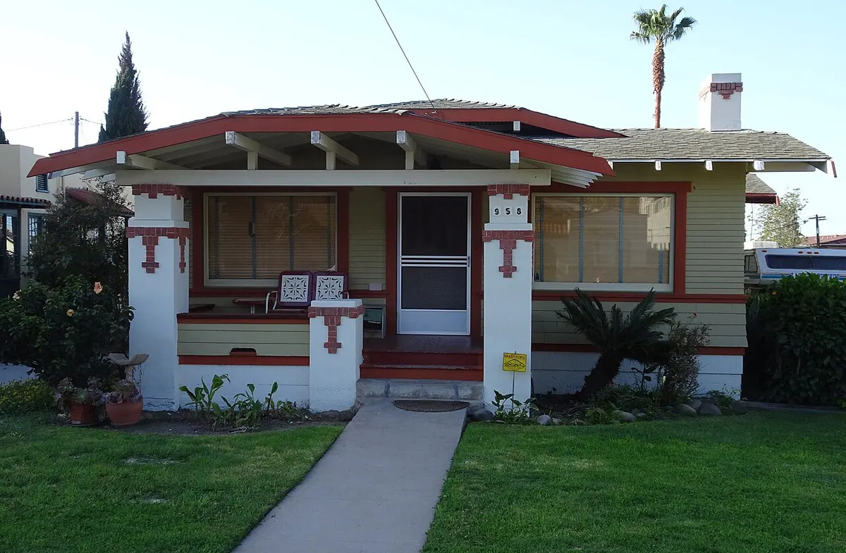 One-story Craftsman bungalow with a low gabled roof, exposed rafter tails and a full-width front porch
